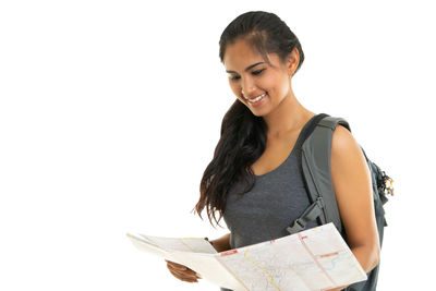 Young woman smiling against white background