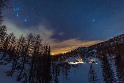 Scenic view of snowcapped mountains against sky at night