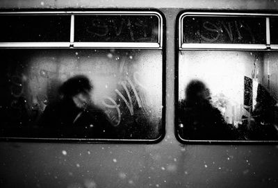 Shadow of woman on train window