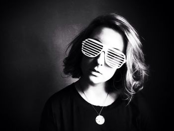 Portrait of young woman wearing striped sunglasses