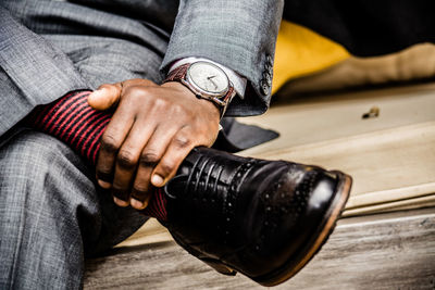 Low section of businessman sitting on bench