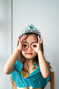 A child girl dressed in arabian princess costume against white background. natural light.