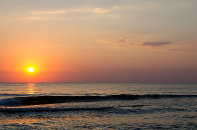 Scenic view of sea against romantic sky at sunset