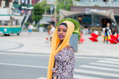 Portrait of woman standing on city street