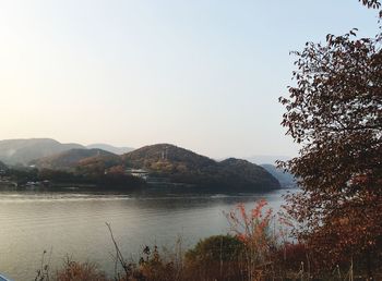 Scenic view of lake and mountains against clear sky