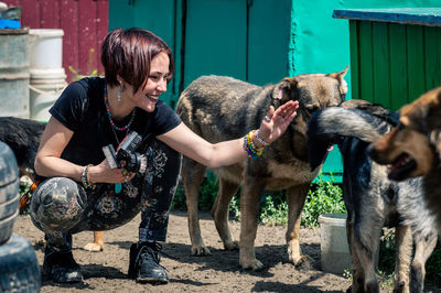 Dog at the shelter. animal shelter volunteer takes care of dogs. lonely dogs in cage with volunteer.