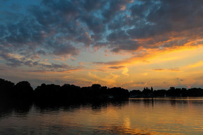 Scenic view of lake against sky during sunset