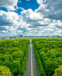 Road amidst green landscape against sky
