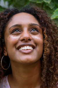 Portrait of a black woman with afro hair and glitter on her face