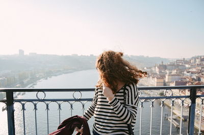 Woman standing against river