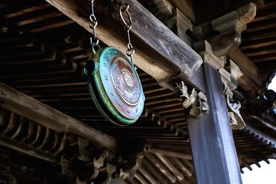 Low angle view of decoration hanging against wooden roof in temple