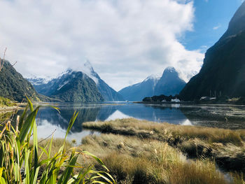 Scenic view of lake and mountains against sky