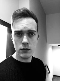 Portrait of young man at home