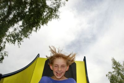 Portrait of smiling boy against sky