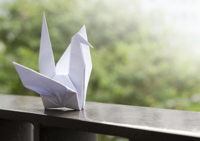 Close-up of white paper on table against blurred background