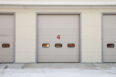 Front wall of car repair station with numbered doors