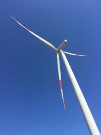 Low angle view of vapor trail against clear blue sky