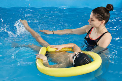 Young woman swimming in pool