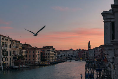 View of buildings in city at sunset