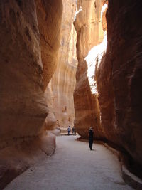 Rear view of man walking on rock