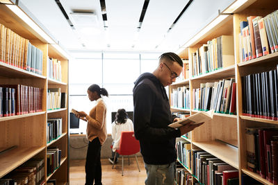 Man and woman standing on book