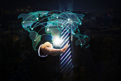 Digital composite image of hand with light painting