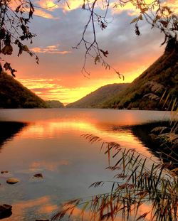 Scenic view of lake against orange sky
