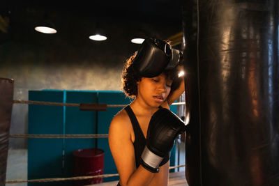 Side view of young woman exercising in gym