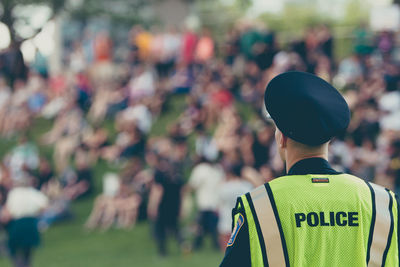 Rear view of people against blurred background