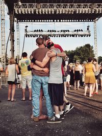 Friends embracing during music concert