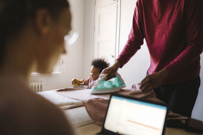 Family with daughter working and doing chores at home