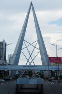 Low angle view of bridge against cloudy sky