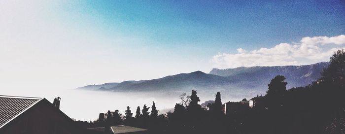 Scenic view of mountains against cloudy sky