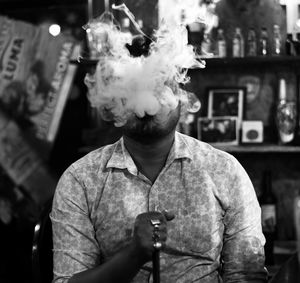 Young man smoking hooka