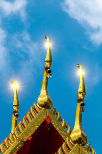 Low angle view of statue against blue sky