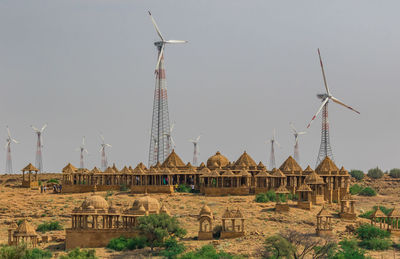 Traditional windmill on field against clear sky