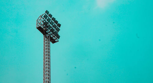 Low angle view of crane against blue sky