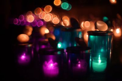 Close-up of illuminated light candles on table