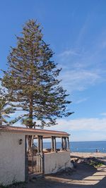 Built structure by sea against sky