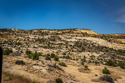 Scenic view of rocky landscape against clear blue sky