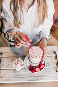 Midsection of woman holding ice cream