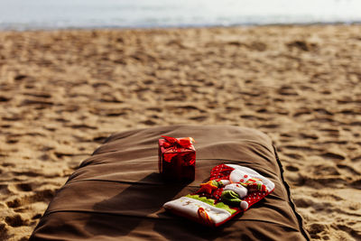 High angle view of christmas presents on pillow at beach