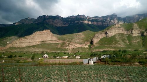 Scenic view of landscape against cloudy sky