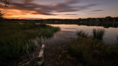 Scenic view of lake against sky during sunset