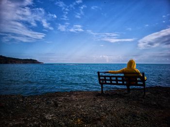 Rear view of one people sitting on chair at beach