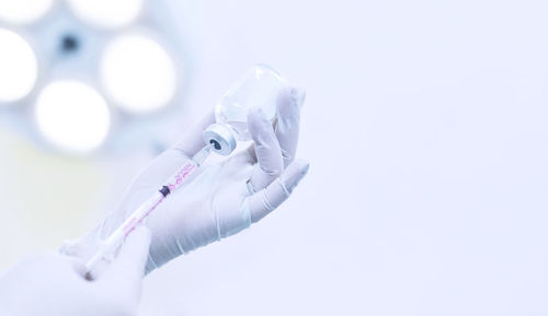 Close-up of human hand over white background