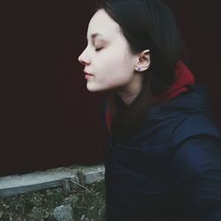 Young woman with eyes closed standing outdoors