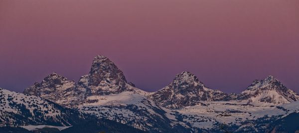 Scenic view of snowcapped mountains against clear sky