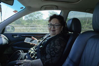 Portrait of woman sitting in car