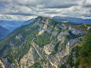 Scenic view of mountains against cloudy sky